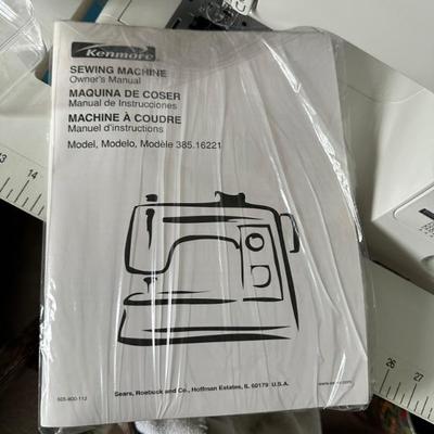 Kenmore Sewing Machine Model 385.16221 with accessories and sewing machine table