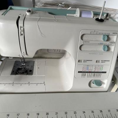 Kenmore Sewing Machine Model 385.16221 with accessories and sewing machine table