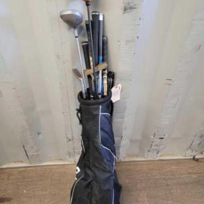 #4710 â€¢ Mizuno Golf Bag with Assorted Golf Club Poles and Putters
