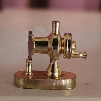 The smallest of golden sewing machines