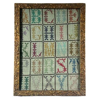 Needlepoint Alphabet | Needlepoint alphabet practice in floral gilt frame. - l. 13.5 x h. 17.5 in
