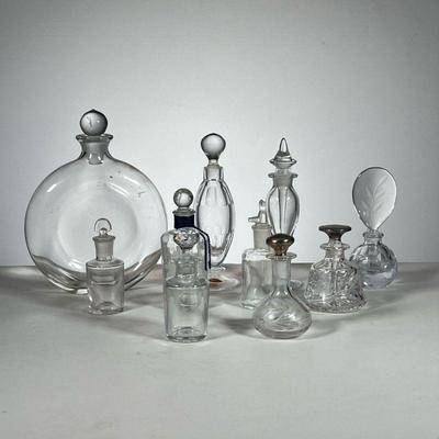 Clear Glass Perfume Bottles | Assorted clear glass perfume bottles. Some cut glass, some with sterling silver tops. - l. 6.5 x w. 1.5 x...