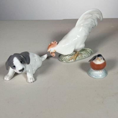 (3pc) Royal Copenhagen Rooster-Dog-Robin | Lot Includes: #1127 White Rooster #1311 Puppy Dog #2238 Small Robin. - l. 5 x w. 1.5 x h. 3.5 in 