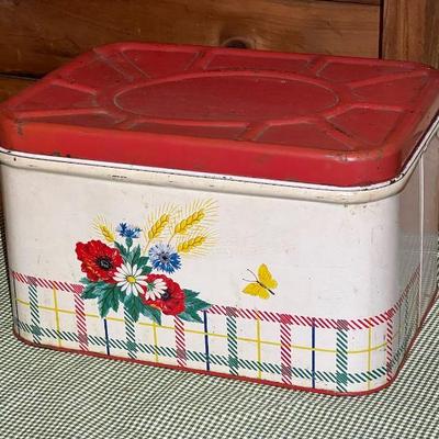 Vintage Metal Bread Box Flower Design With Red Top Filled With Linens
