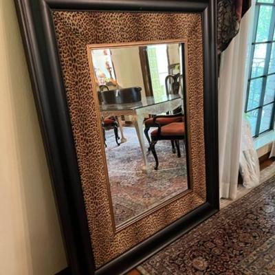 Big mirror framed with leopard print.