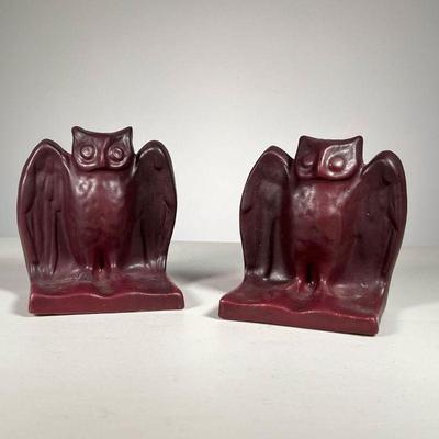 (2pc) ART POTTERY OWL FORM BOOKENDS | Owl perched on an open book in deep purple/red glaze, no apparent mark. 
