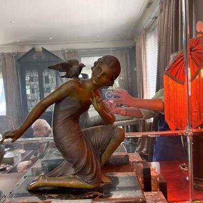 French Art Deco spelt statue of a woman with birds, bronze finish and marble base