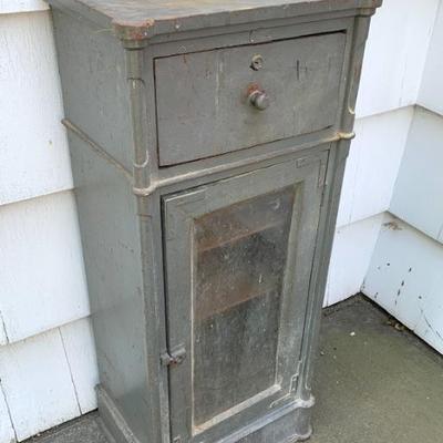Small funky cabinet in grey paint.