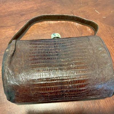 Lot 012-LOC: Vintage â€œMadwedâ€ Handbag 

Features: Vintage 1950â€™s Madwed petite handbag with brass trim and clasp. Appears to be...
