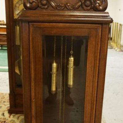 1139	GERMAN GRANDFATHERS CLOCK IN OAK CASE W/APPLIED CARVINGS ON BONNET, NO PENDULUM, APPROXIMATELY 25 IN X 12 IN X 77 IN HIGH
