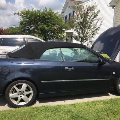 The 2004 Saab model 9-3 has 124,120 miles, Vin # Y53FD79Y146002027 is navy blue with a black convertible top, white leather upholstery...