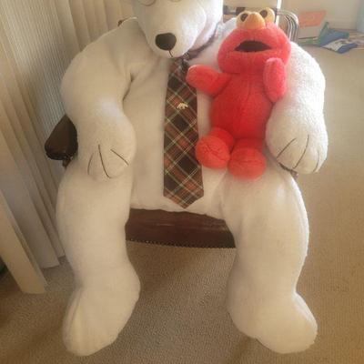Pretty large Teddy Bear holding Elmo