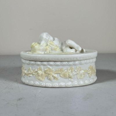 Belleek Box | Oval lidded box with a sleeping baby on the lid. - l. 4.75 in 
