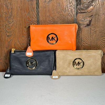 (3pc) Michael Kors Wallets | Soft, leather wallets one in orange, one in black, and one in light brown leather. - l. 7.25 x w. 4.25 in...