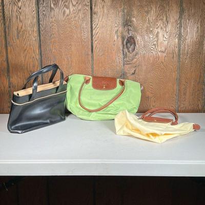 (3pc) Longchamp Bags | Including a black leather purse, and two nylon bags, one green, the smaller one a light, pale yellow. - w. 11.75 x...
