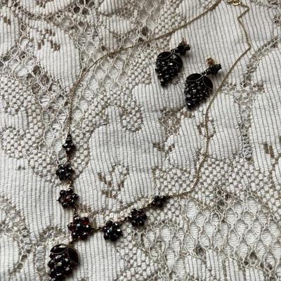 14 karat and garnets. One missing garnet in flower