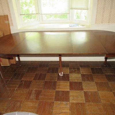 Dining table shown with all three leaves in place