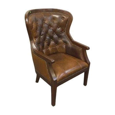 Rich dark brown leather tufted library chair with a beautiful curved back and solid wood details. This piece measures 43" in height,...