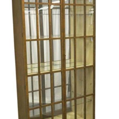 A Tall American Vitrine Cabinet, Baker, from the Collector's Series. Walnut finish with carved cavetto cornices over double glass...