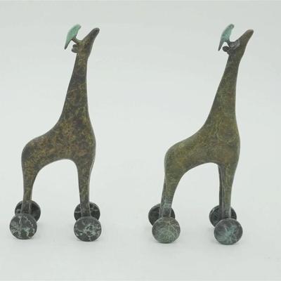 Pair of Contemporary Whimsical Bronze Patinated Giraffes on Wheels with Parrots. Each 3"x1.25"x7". Weight 1 pd 13 oz....