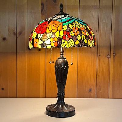 STAINED GLASS LAMP W/ORANGE FLOWERS | Molded base in a bronze color. Shade is multi-colored. - h. 28 x dia. 15 in 