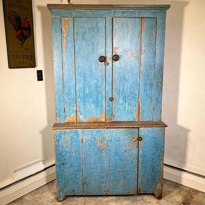 STEPBACK CUPBOARD IN BLUE PAINT | 19th C StepBack Cupboard in old blue paint. One-piece construction with two doors over one. - l. 42 x...