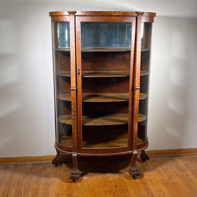 OAK CHINA CLOSET | Oak Curved Glass China Closet with four shelves and lionâ€™s paw feet. - l. 38 x w. 14 x h. 62 in 