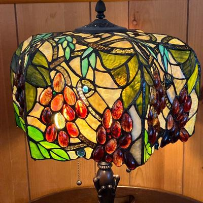 STAINED GLASS CONCAVE LAMP | Concave shade featured bunches of grapes over bronze color base with green teardrops. On four feet. - h. 25...