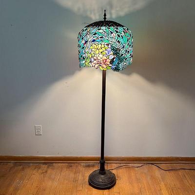 PEACOCK STAINED GLASS FLOOR LAMP | Helmet style shade with Peacockâ€™s tail feathers in green and blue. Flower design base in bronze...