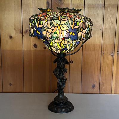 STAINED GLASS LAMP W/BUTTERFLIES | Ornate base with flowers in a bronze color. Shade has blue flowers with three butterflies mounted on...