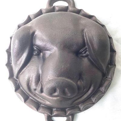 JIFI933 Vintage Cast Iron Pig-Shaped Mold	20th century baking pan with handles. Â Approximately 11 inch wide x 3.25 inch, unknown maker.
