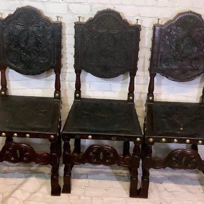 LAGO702 Antique Embossed Leather Portuguese Side Chairs	Set of 3 chairs with 1' diameter brass tacks and handtooled leather

