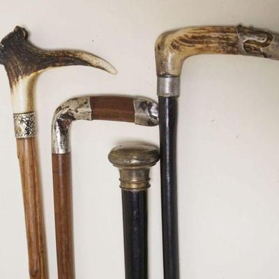 1015	LOT OF 4 ASSORTED ANTIQUE CANES/WALKING STICKS SOME W/STAG HANDLES & METAL BANDS, TALLEST APPROXIMATELY 36 IN
