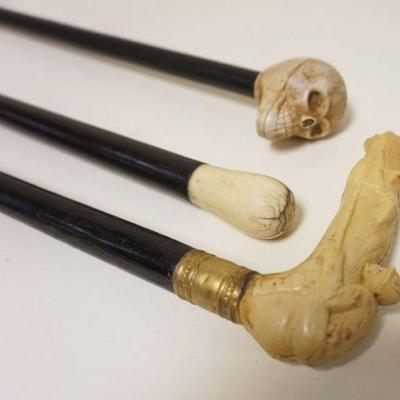 1017	LOT OF 3 CANES/WALKING STICKS INCLUDING SKULL & JOCKEY ON HORSE, ALL HAVE COMPOSITE HEADS, TALLEST APPROXIMATELY 38 IN
