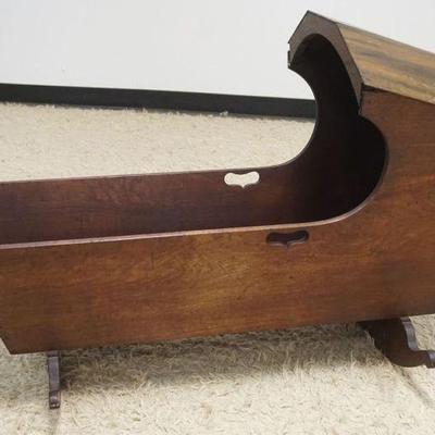 1295	ANTIQUE WALNUT HOODED CRADLE W/FINE DOVETAILING, LOSS TO ONE SIDE OF ROCKER, APROXIMATELY 26 IN X 43 IN X 30 IN HIGH
