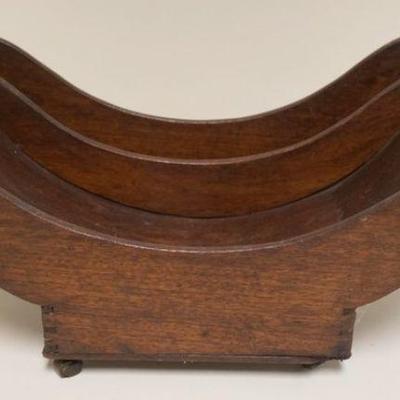 1037	ANTIQUE MAHOGANY CONCAVE BASE WITH DOVETAILED CONSTRUCTION DIVIDED HOLDER WITH BRASS CASTORS
