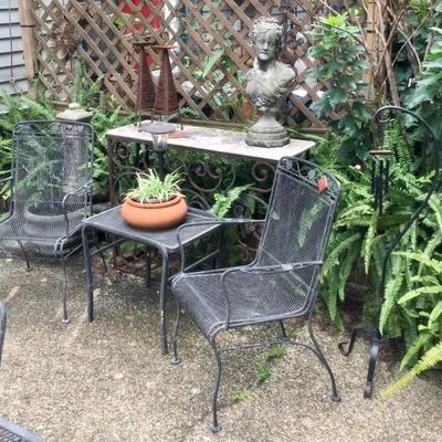 Concrete bust, iron table and chairs