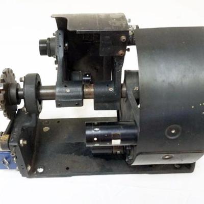 1142	MULTI LENS 16 MM PROJECTOR LENS CHANGER, APPROXIMATELY 16 IN X 11 IN X 11 IN
