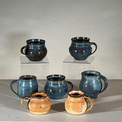 (6PC) RICK CROWN & OTHERS GLAZED MUGS | Mixed set of blue and tan glazed mugs, some by Rick Crown, some by others. - h. 4.5 x dia. 4 in...