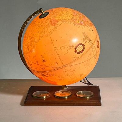 GEORGE F. CRAM LIGHTED GLOBE | Plastic globe on wooden base with lightbulb in the center. Hydrometer, barometer, and thermometer set into...