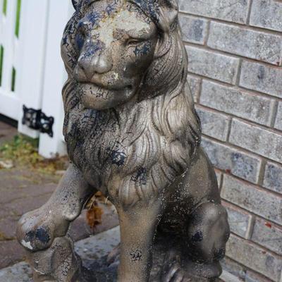 There is a pair of vintage cement lions . they have been repainted. 