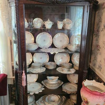 Oak china cabinet with curved sides with pretty Theodore Haviland Limoges France china set