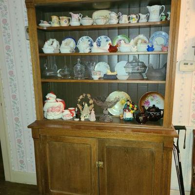 Step back cabinet, nice collection of hen on nests, creamers and covered candy dishes.