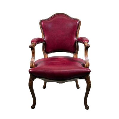 RED LEATHER ARMCHAIR | Carved wood and leather armchair with riveted border, rounded back and curved arms, and carved legs and feet. - l....