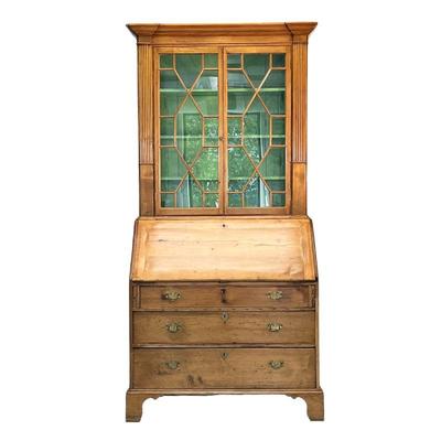 SLANT LID BOOKCASE | Pine slant lid bookcase with 2 glass paneled doors leading to a flip top secretary desk with many storage cabinets...