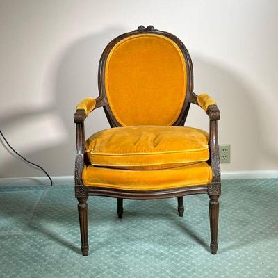 VINTAGE FRENCH STYLE ARMCHAIR | With orange/brown upholstery and cushion. Ornately carved wood. - l. 24 x w. 22.5 x h. 35 in 