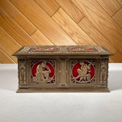 BRASS GRECO ROMAN STYLE COFFER | Brass coffer with Greco Roman style scenes in square relief on top and front, interior padded red velvet...