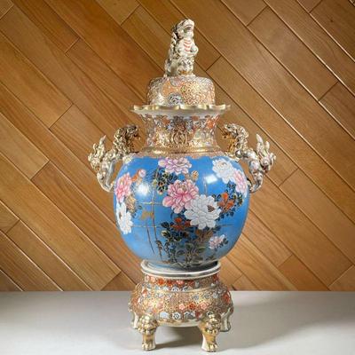 LARGE LIDDED CHINESE VASE ON STAND | Intricate and colorfully painted lidded Chinese vase with gilt lion figurine on top and side with...