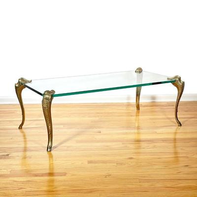 SPANISH GLASS AND BRASS LOW TABLE | Finely cast and chased brass cabriole legs affixed to a tempered glass top, marked 