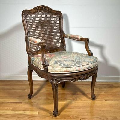 FRENCH CARVED ARM CHAIR | Cane seat and backrest carved decorations. - l. 26 x w. 24 x h. 36 in 